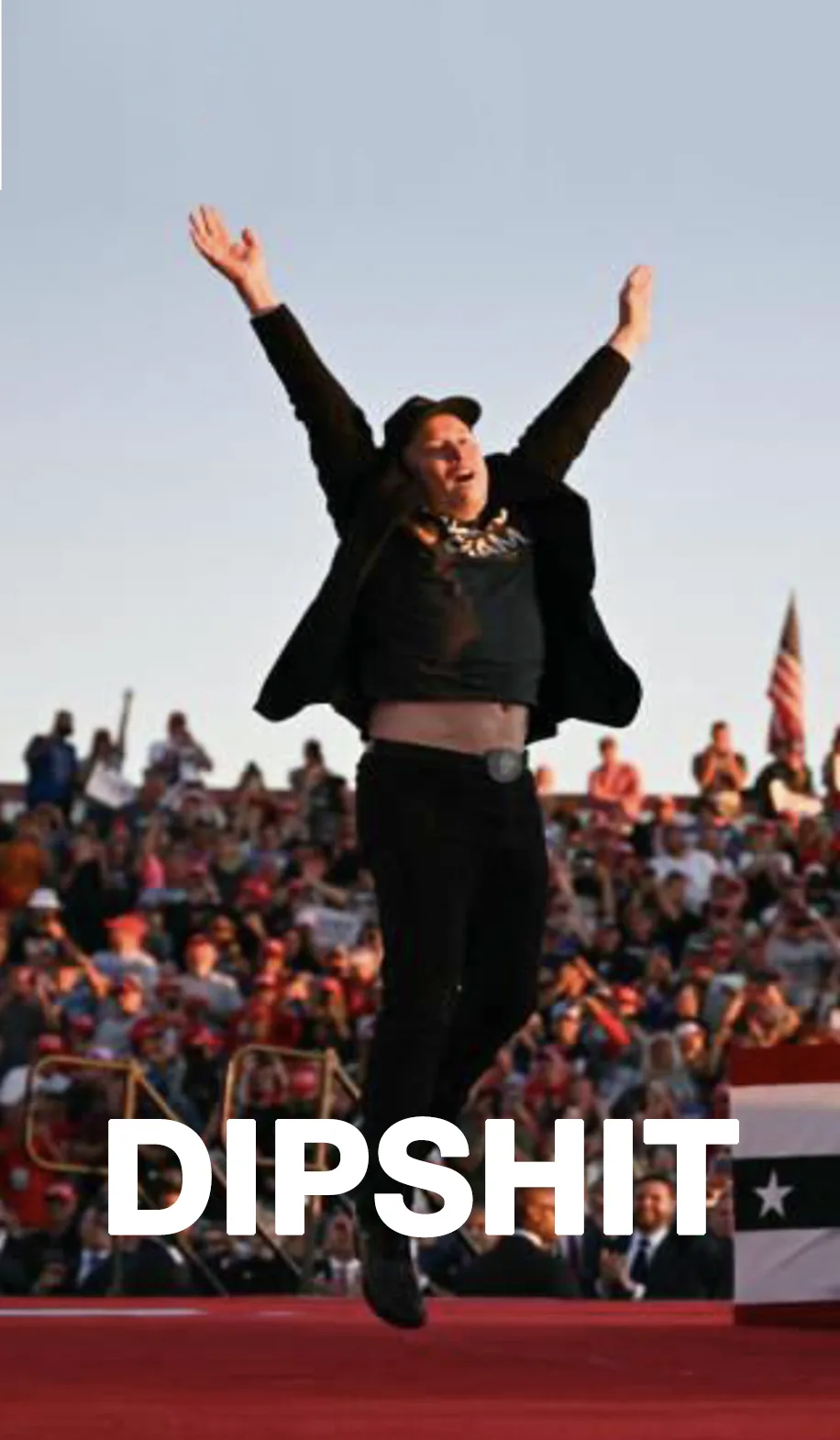 A man in a black outfit and cap is captured mid-air with arms raised in a triumphant or ecstatic pose, standing on a red…