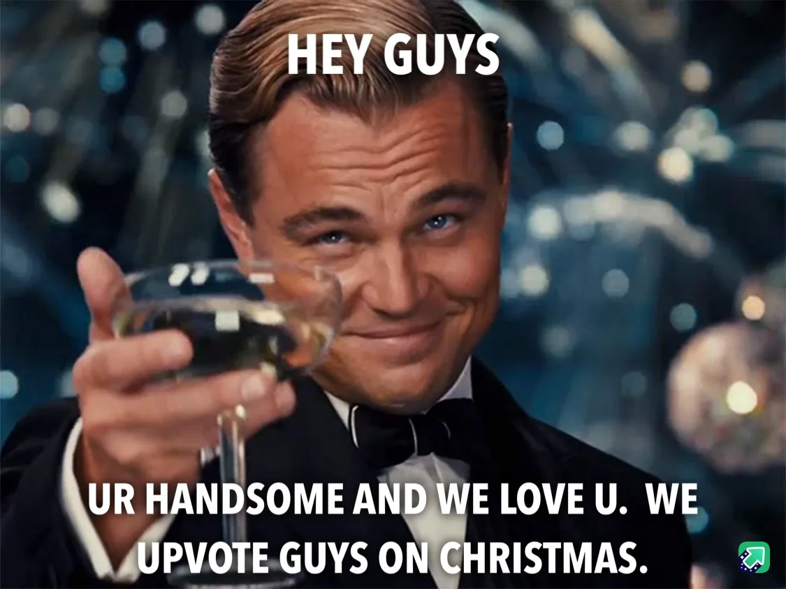 A man in a tuxedo holding a glass of champagne smiles and looks at the camera. White text overlaid on the image reads 'HEY…