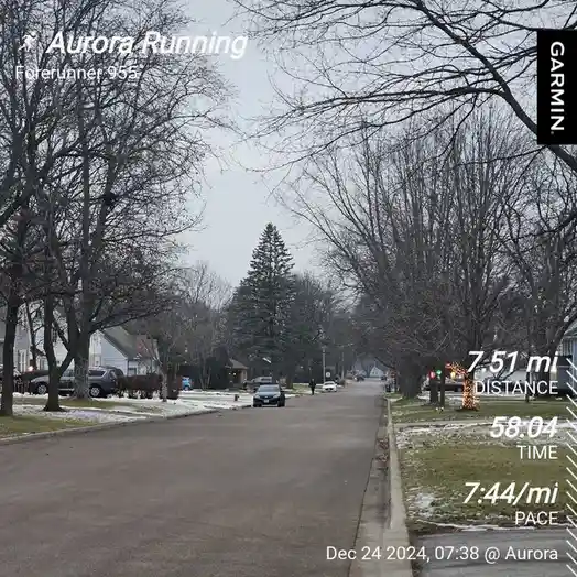 A screenshot from a Garmin Forerunner 955 GPS watch showing a winter run in Aurora, with bare trees lining a residential…