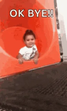 A sequence of six images shows a young child in a red plastic slide tunnel. In the first frame, the child is at the top…