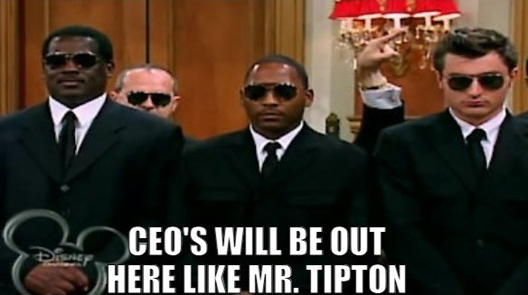 Three men in black suits and sunglasses stand in a formal room, one pointing upward. The Disney logo is visible in the…