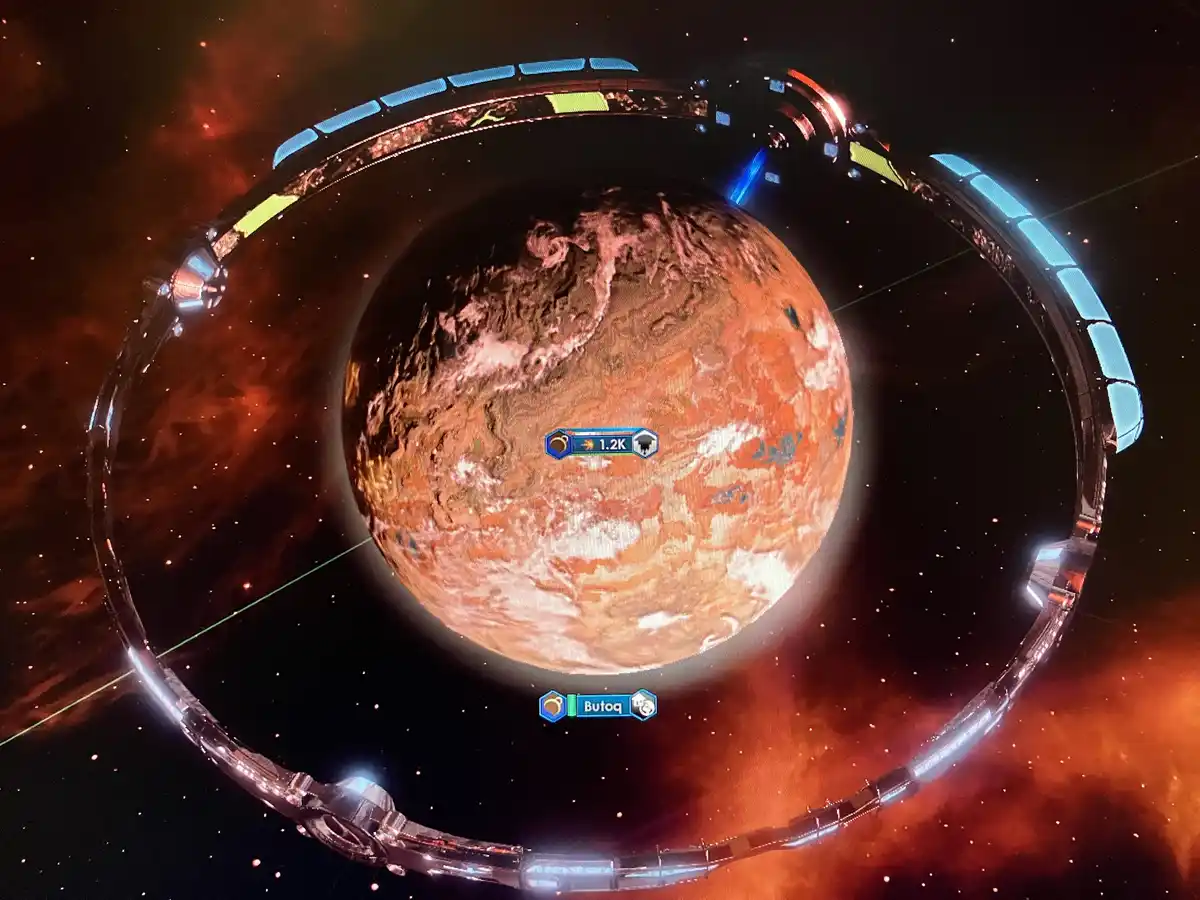 A screenshot from a space strategy game shows a large, reddish-brown planet named 'Butoq' encircled by a massive, glowing…