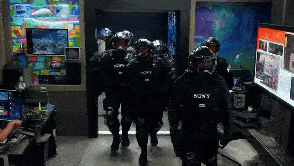 A split-screen image from the movie 'The Interview' shows a group of armed, helmeted men in black tactical gear with 'SONY'…