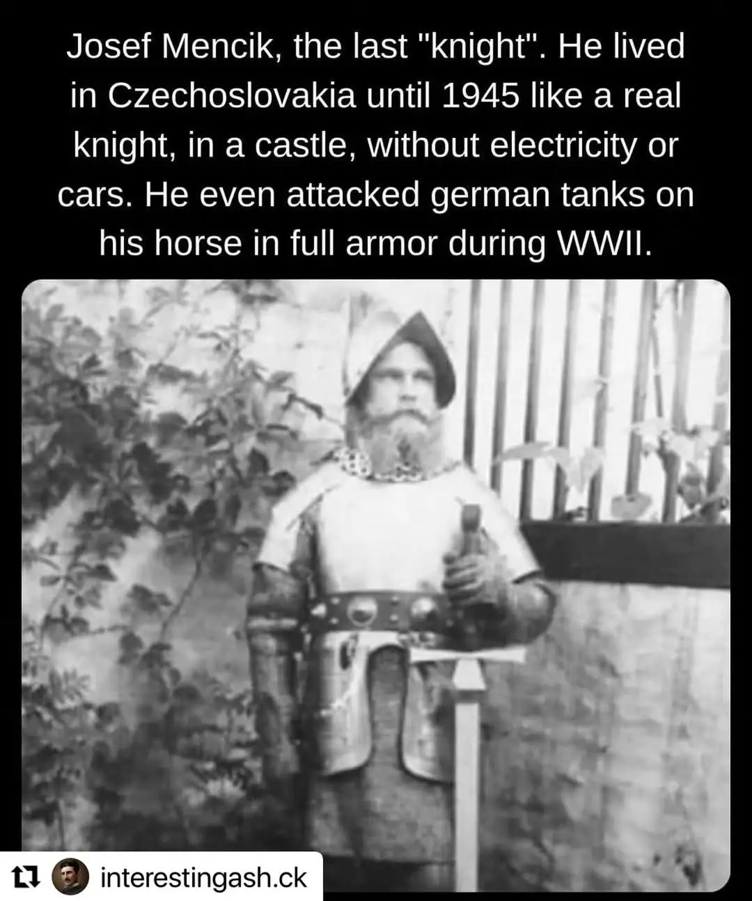 A black-and-white photo shows a man in full medieval knight armor, including a helmet and chainmail collar, standing…