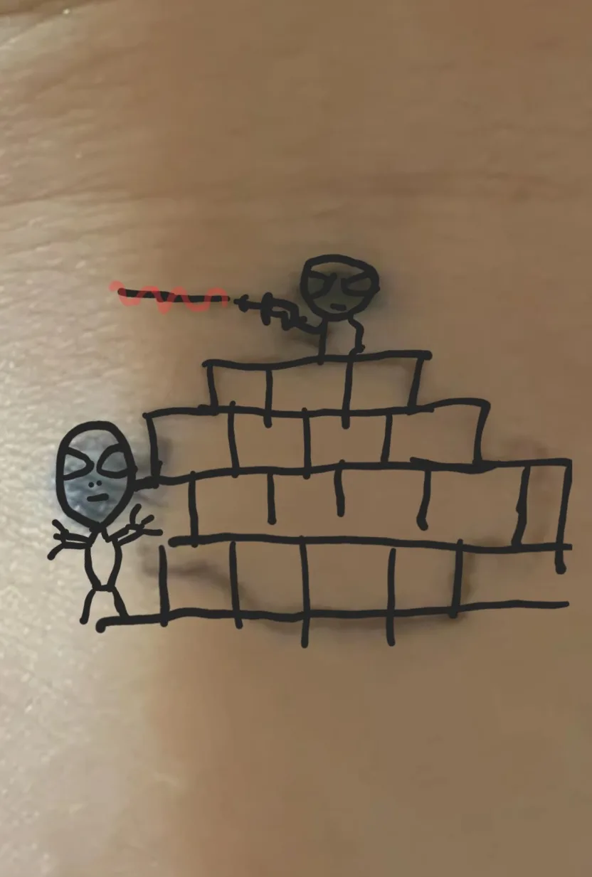 A hand-drawn stick figure alien with a gray face and large eyes stands at the base of a brick wall, gesturing with both…