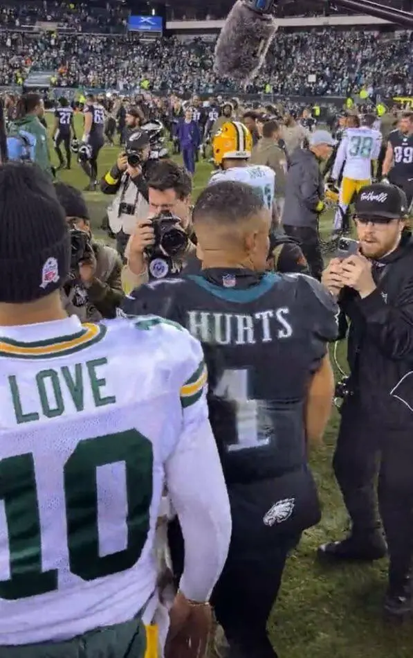 Two football players, one in a Green Bay Packers jersey with 'LOVE 10' on the back and another in a Philadelphia Eagles…