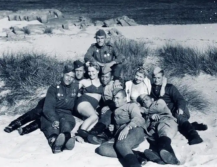 Soldiers and Danish girls share a moment on Bornholm Island in 1945.