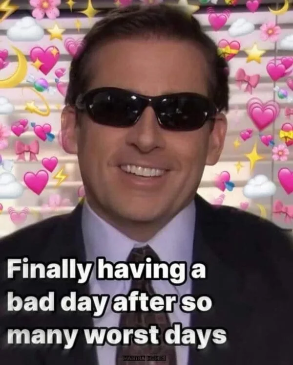 A man wearing sunglasses and a suit smiles while surrounded by a background filled with pink hearts, stars, clouds, and…