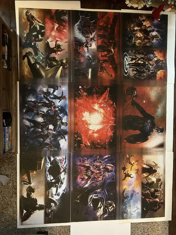 A partially completed jigsaw puzzle depicting various scenes from the Avengers movie franchise, laid out on a carpeted…