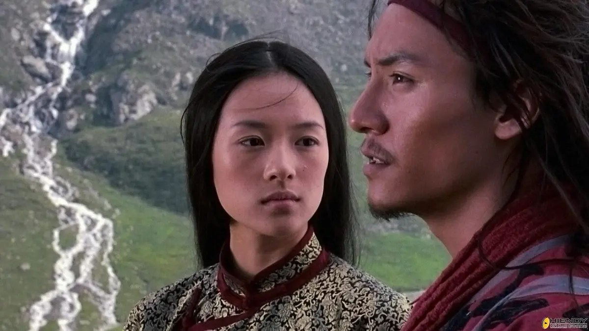 A still from the movie 'Crouching Tiger, Hidden Dragon' shows a woman in traditional Chinese attire looking forward with a…