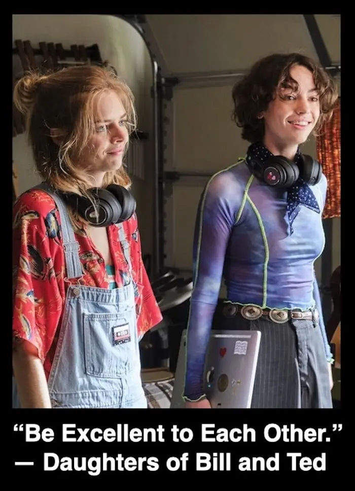 Two young women stand side by side in a garage-like setting, both wearing headphones around their necks. The woman on the…