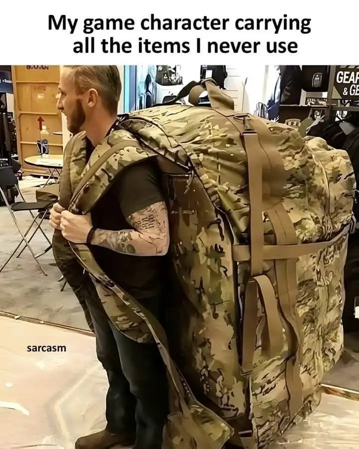 A man with a beard and tattooed arm stands in what looks like a gear store, wearing a massive, oversized camouflage backpack…