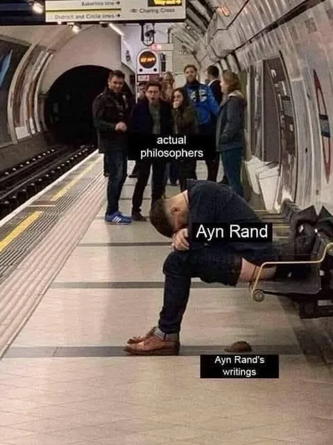 A man sits slumped on a subway platform bench, head in hands, labeled 'Ayn Rand,' with a pile of books labeled 'Ayn Rand's…