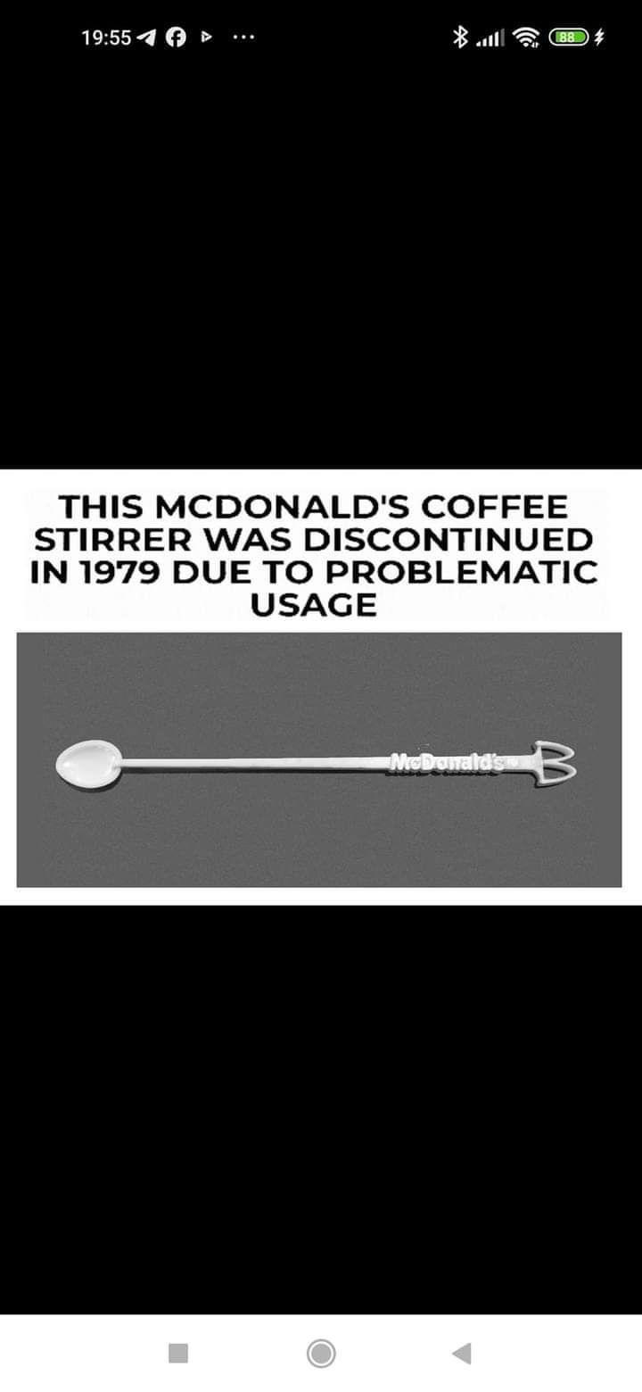 A black and white photo shows a long, thin plastic stirrer with a spoon at one end and a fork-like prong at the other…