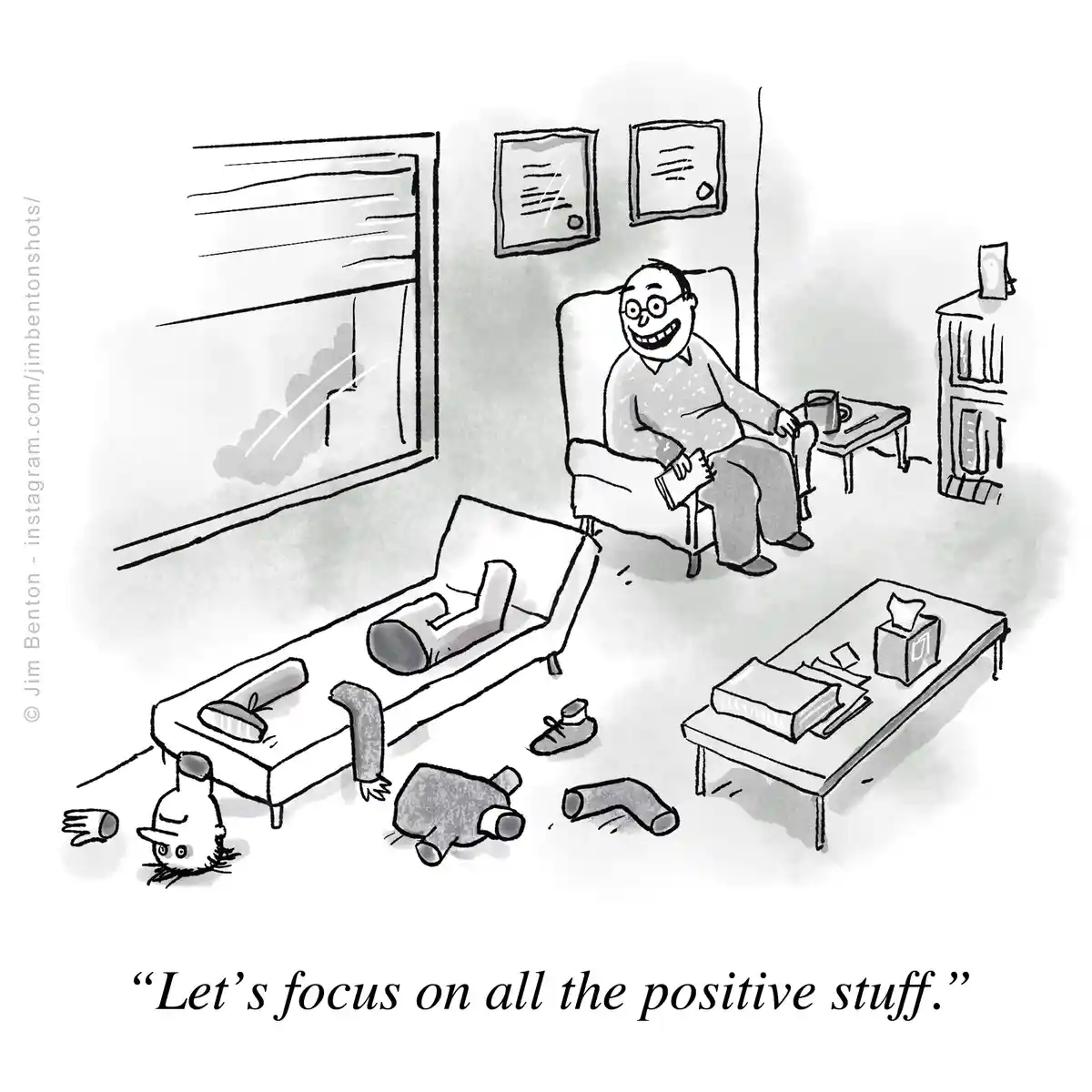 A black-and-white cartoon depicts a cheerful man in a chair in a messy living room, smiling while holding a book. The room…