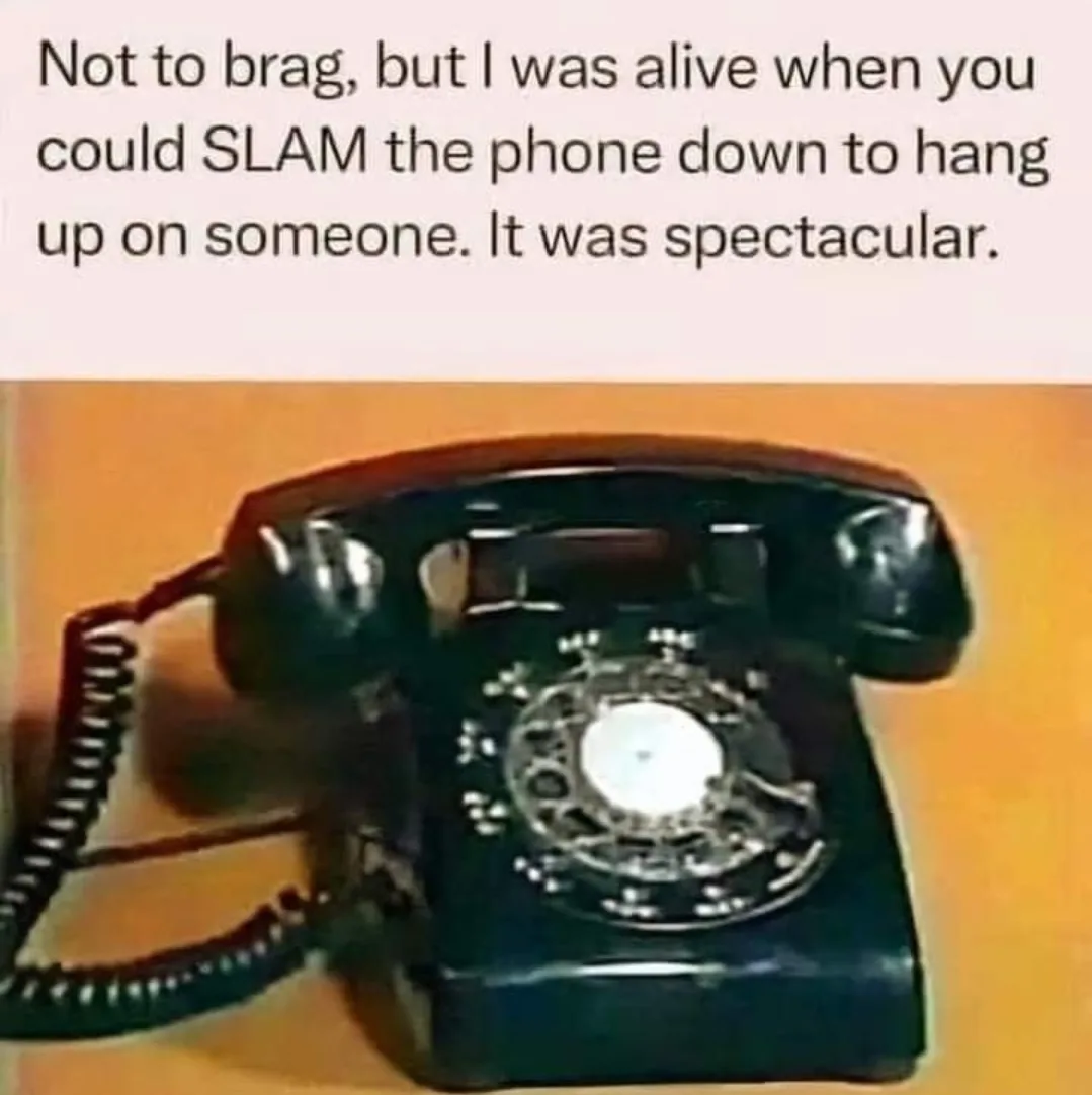 A black rotary telephone with a coiled cord rests on a wooden surface. The overlaid text reads: 'Not to brag, but I was…