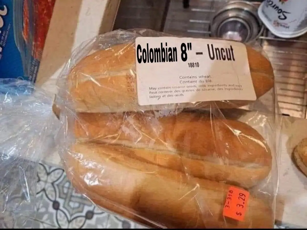 A close-up photo shows three long, uncut baguettes wrapped in clear plastic, with a white label that reads 'Colombian 8"…