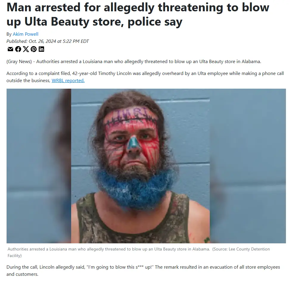 A mugshot of a man with red and blue face paint and a blue beard, taken against a plain blue wall. The image is overlaid…