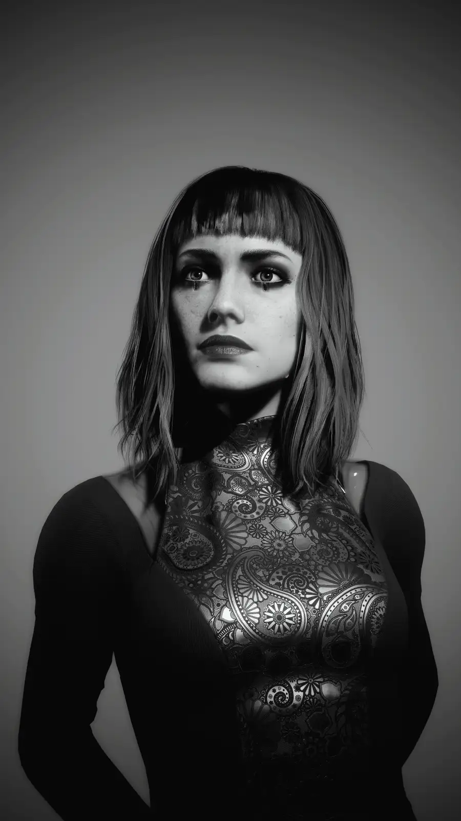 A black-and-white portrait of a woman with bangs and dark lipstick, her eyes are visibly shedding tears. She wears a dark…