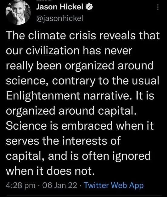 A screenshot of a tweet by Jason Hickel showing a block of white text on a black background. The text argues that…