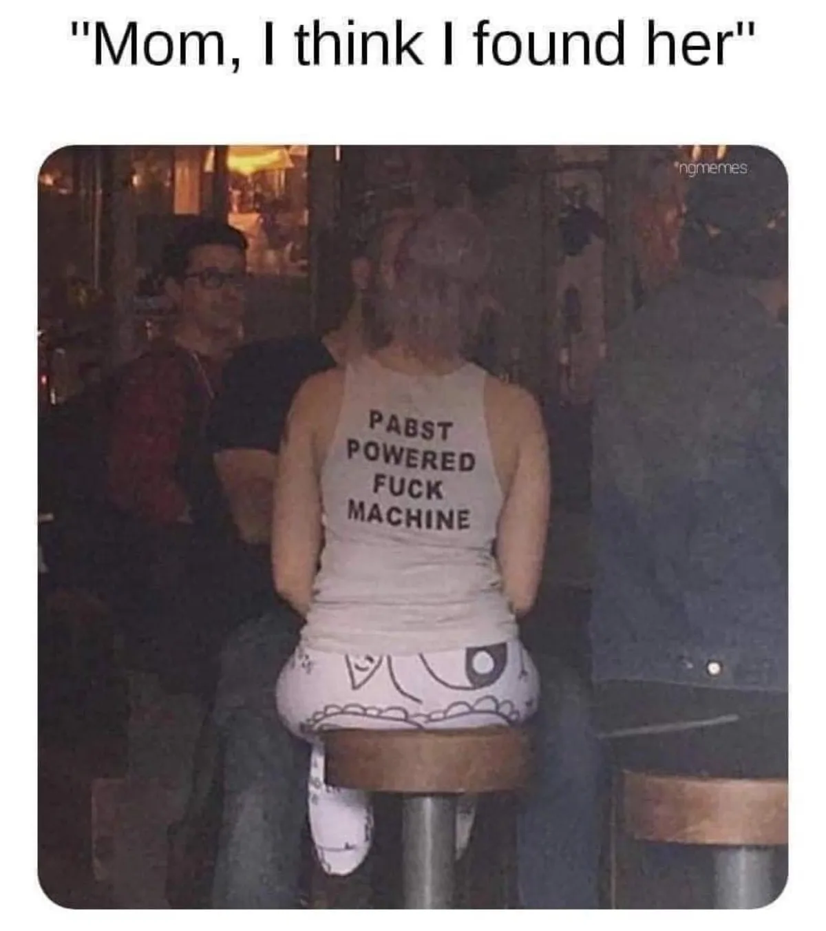 A person is seen from behind, sitting on a bar stool in a dimly lit establishment, wearing a white tank top with the text…