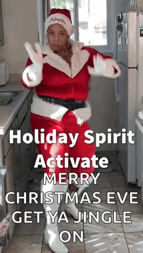 A woman in a red and white Santa Claus costume dances energetically in a kitchen, with text overlaid that reads 'Holiday…