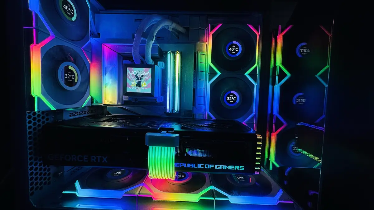 A high-end custom PC build with RGB lighting, showing CPU and GPU temperatures at 40°C and 32°C respectively, and usage at…