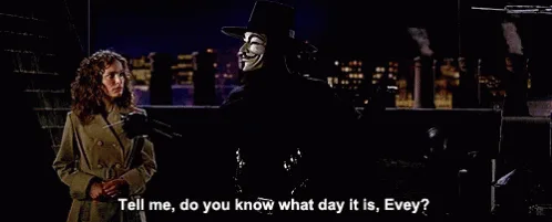 The image shows a repeating scene from the movie V for Vendetta, where a masked man in a black top hat and white mask (V)…