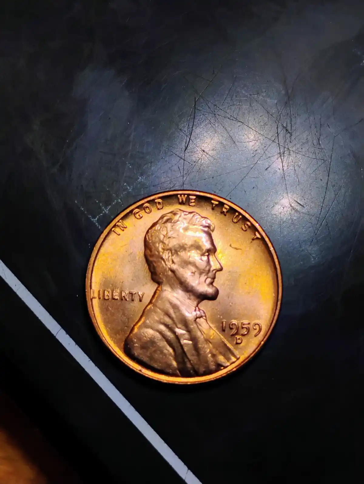 A close-up photo of a 1959-D Lincoln cent penny, showing Abraham Lincoln's profile, the text 'IN GOD WE TRUST' and…