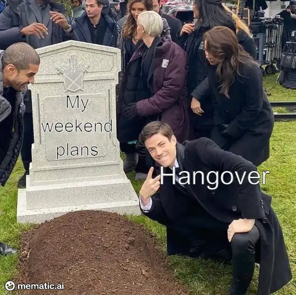 A man in a black coat kneels beside a freshly dug grave with a tombstone that reads 'My weekend plans'. The man, smiling and…