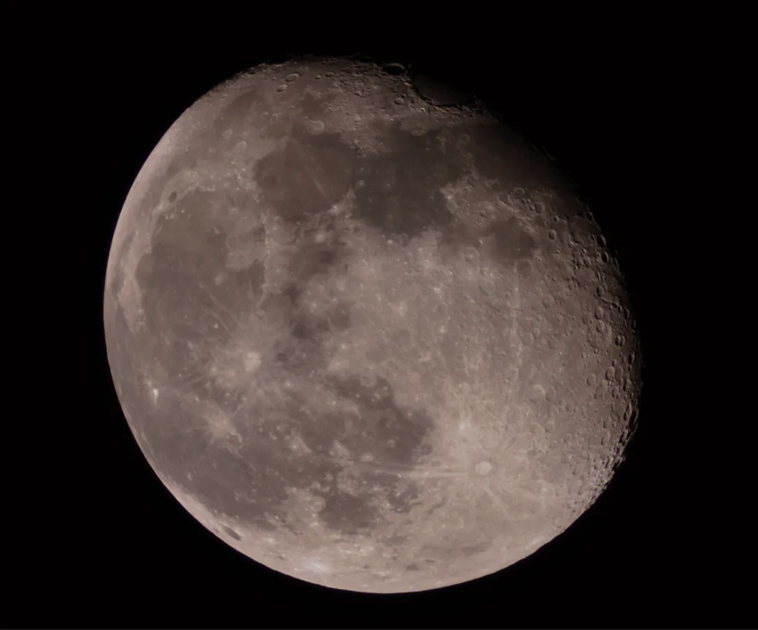 A high-resolution photograph of the moon against a black sky, showing its cratered surface and grayish tones. Overlaid text…