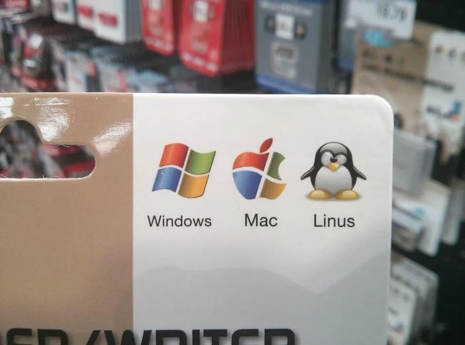 A close-up of a product packaging label showing the Windows logo, the Apple logo, and the Linux penguin mascot, each labeled…