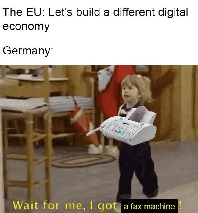 A still image of a young child walking while holding a white fax machine. The text at the top reads 'The EU: Let's build a…