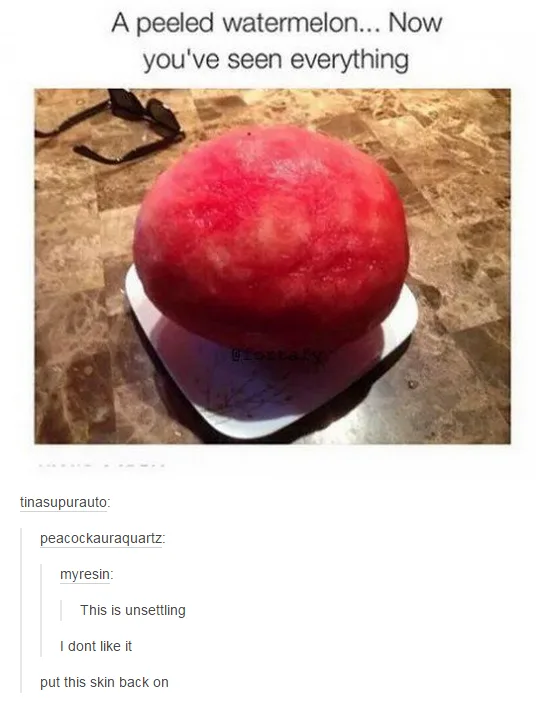 A whole watermelon with its red rind completely peeled off, revealing the pale flesh underneath, sits on a white plate on a…