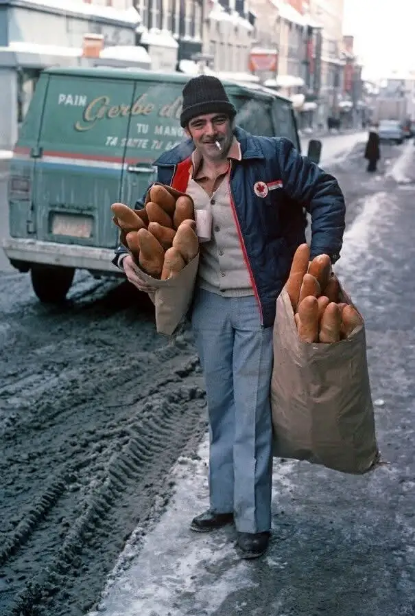 A Nostalgic Scene: A Bread Delivery Man with Baguettes in Snowy Quebec, 1977