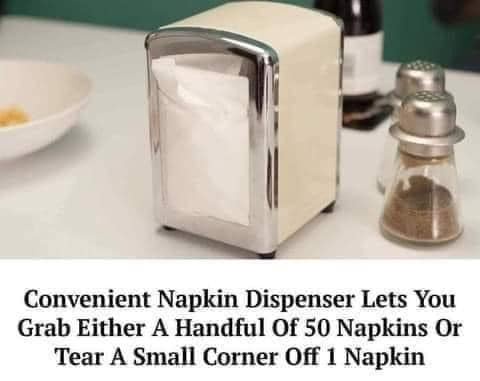 A chrome and cream-colored napkin dispenser sits on a white countertop next to salt and pepper shakers, with a bowl in the…