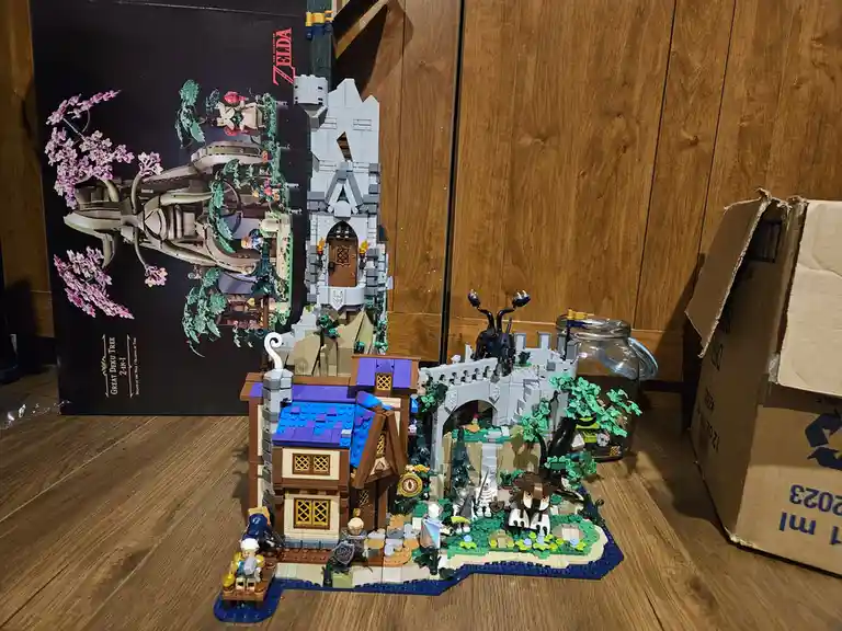 A completed LEGO set of 'The Legend of Zelda: Breath of the Wild' Great Deku Tree, displayed on a wooden floor next to its…