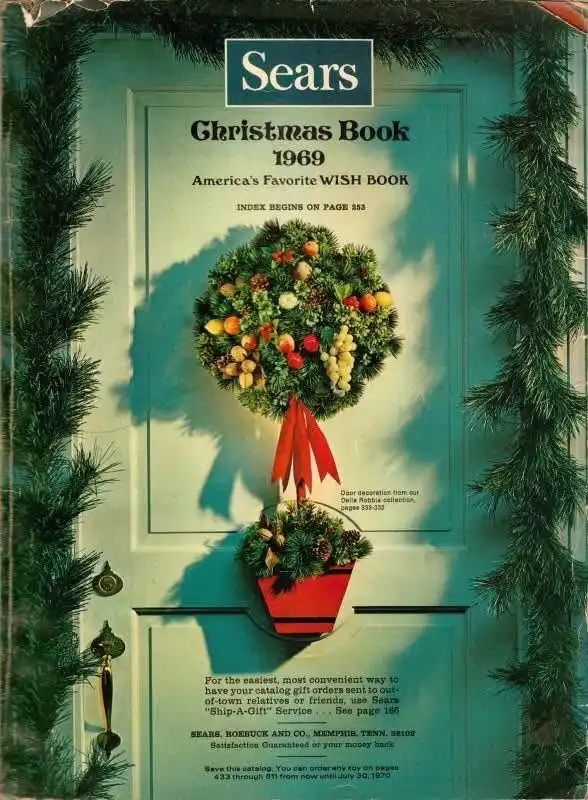The cover of the 1969 Sears Christmas Book shows a festive wreath and potted plant hanging on a door, framed by pine…