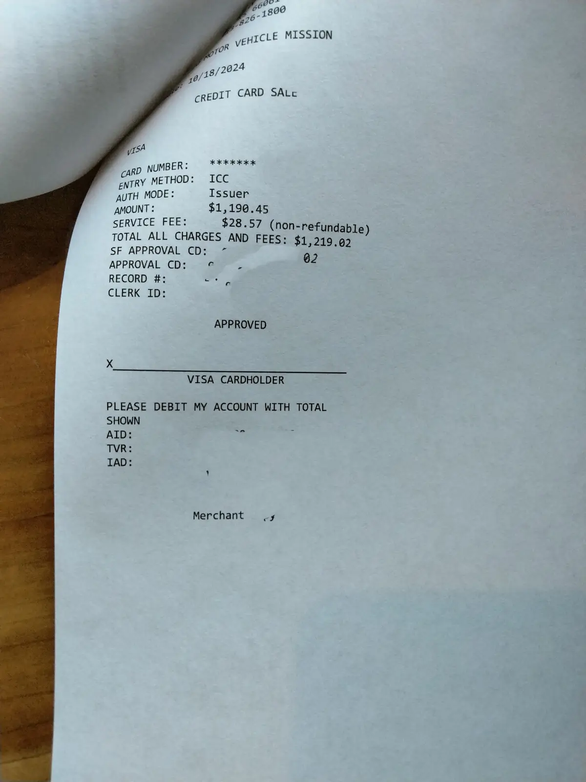 A close-up of a credit card transaction receipt showing a $1,190.45 amount and a $28.57 service fee, totaling $1,219.02…