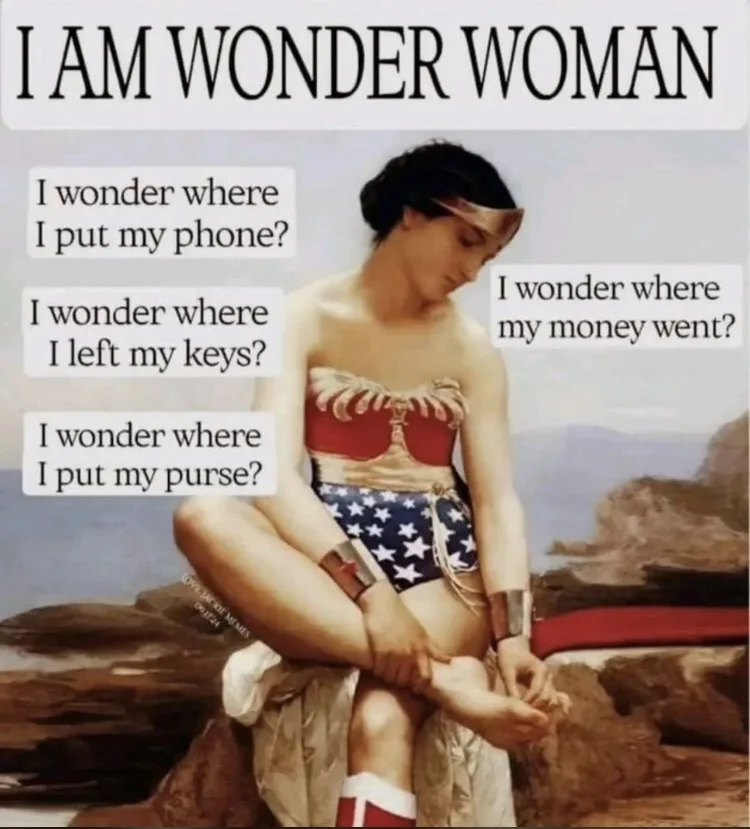 A woman in a Wonder Woman costume sits on a rocky beach, looking downcast while overlaid text reads 'I AM WONDER WOMAN' and…
