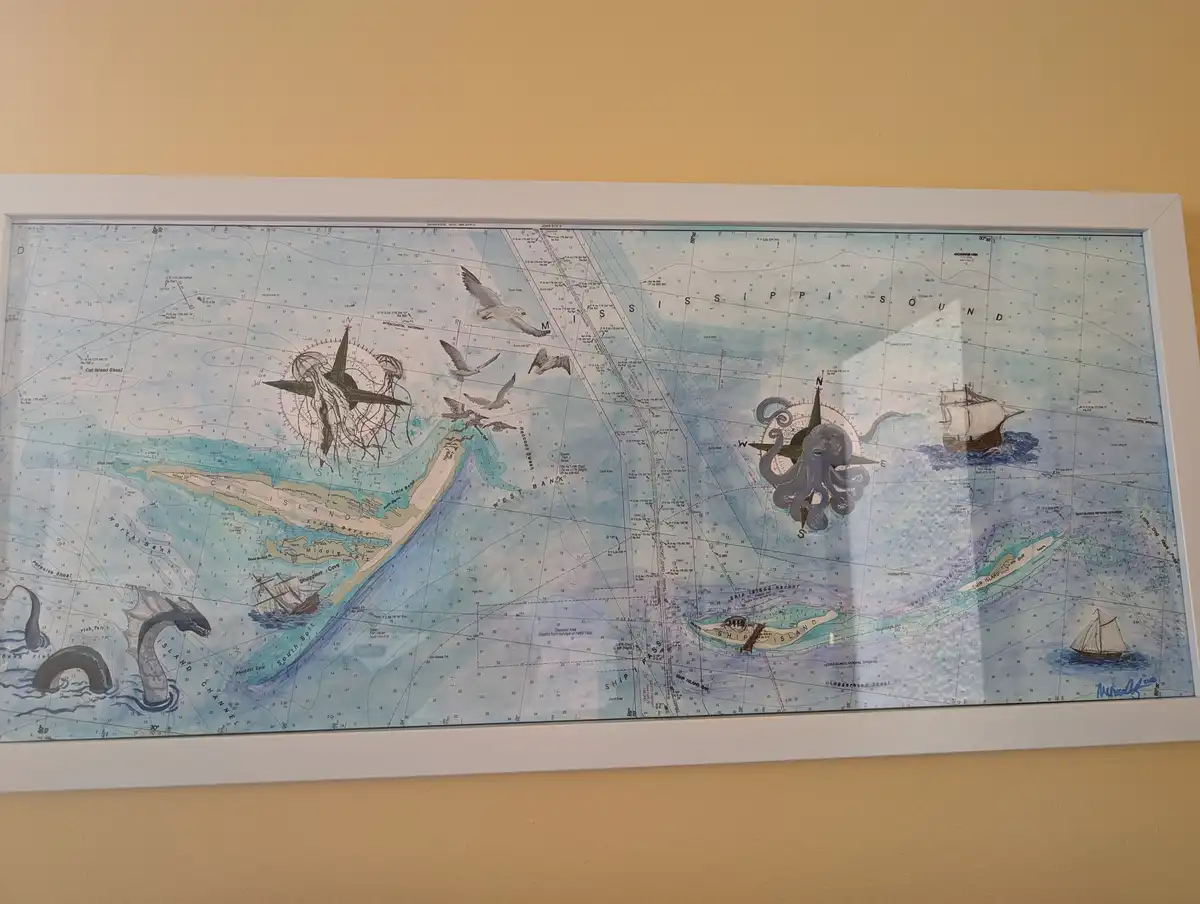 A framed nautical chart of the Mississippi Sound area is overlaid with illustrations of sea monsters including a giant…