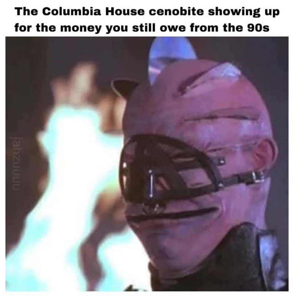 A close-up image of a person wearing a pink, textured mask with a black cage-like structure over the eyes and mouth…