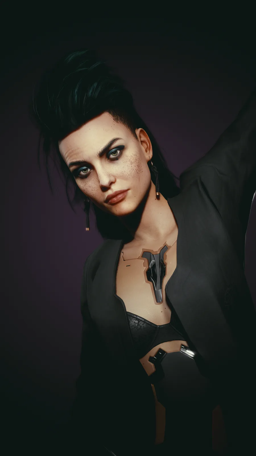 A woman with dark hair and freckles stares intensely at the camera, wearing a black jacket over a black bra. Her chest and…