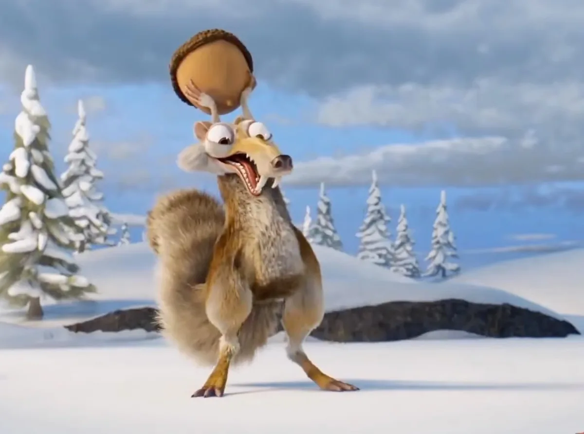 An animated squirrel with wide eyes and an open mouth stands in a snowy landscape, balancing a large acorn on its head…
