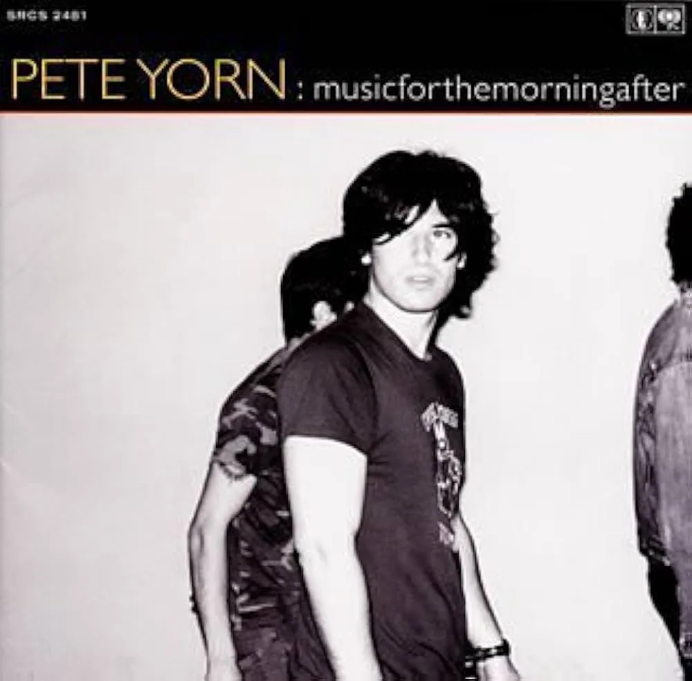 A black and white album cover for Pete Yorn's 'musicforthemorningafter' shows three people standing against a plain…