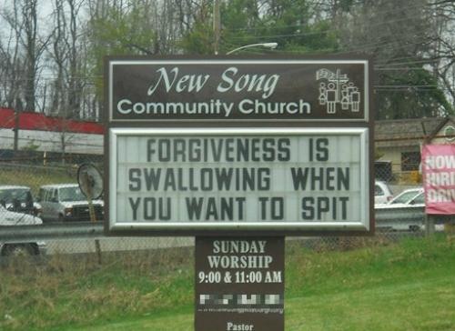 A church sign for 'New Song Community Church' displays a message on its marquee: 'FORGIVENESS IS SWALLOWING WHEN YOU WANT TO…
