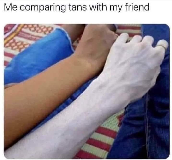 Two arms are shown side-by-side, one with a natural tan and the other extremely pale, almost white, with a ring on the pale…