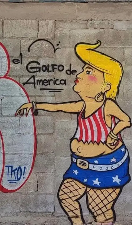 A mural depicts a cartoon woman with blonde hair, wearing a red-and-white striped top and blue star-patterned shorts…