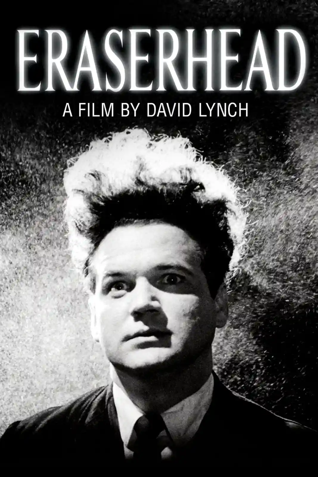 A black-and-white movie poster for 'Eraserhead' by David Lynch, featuring a close-up of a man in a suit and tie with wild…