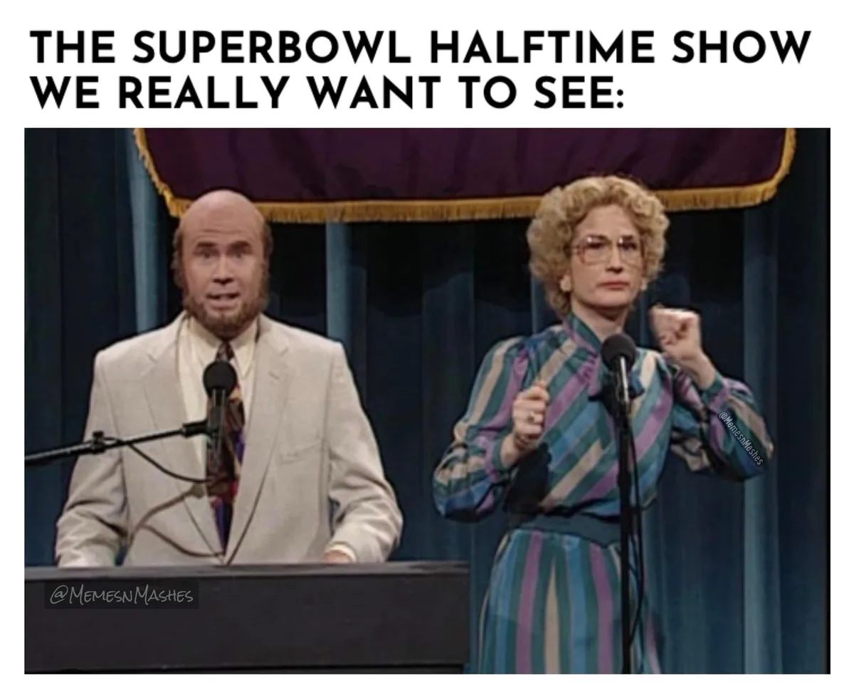 The image shows two people, a bald man in a light-colored suit and a woman with curly blonde hair and glasses in a striped…